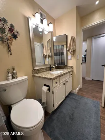 a bathroom with a double vanity sink toilet and shower