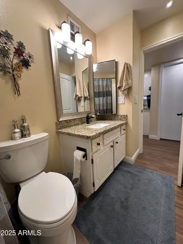 a bathroom with a double vanity sink toilet and shower