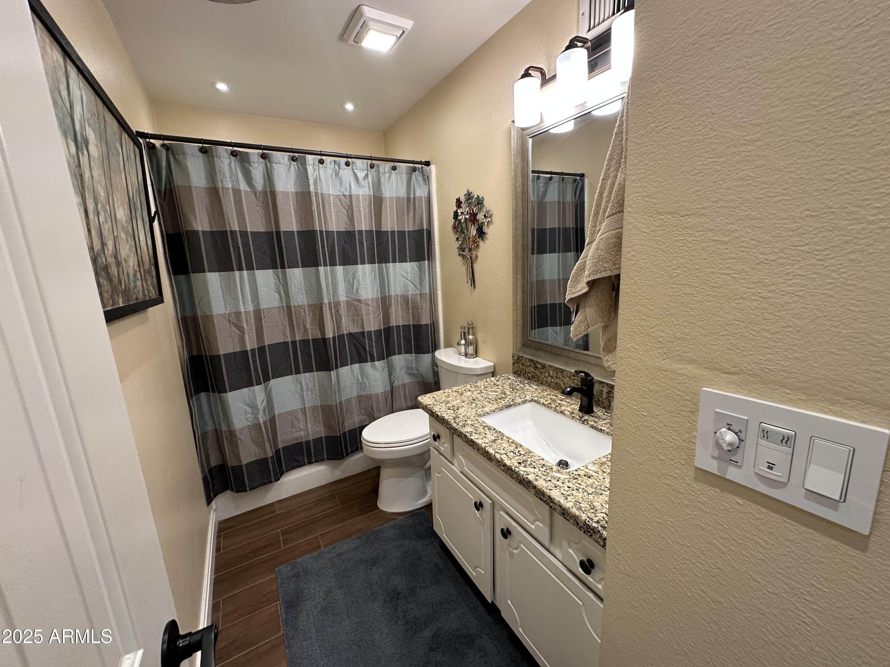 4328 East Capri Avenue, Unit 180 Mesa, AZ 85206 - Photo 34 of 38 a bathroom with a double vanity sink toilet and shower