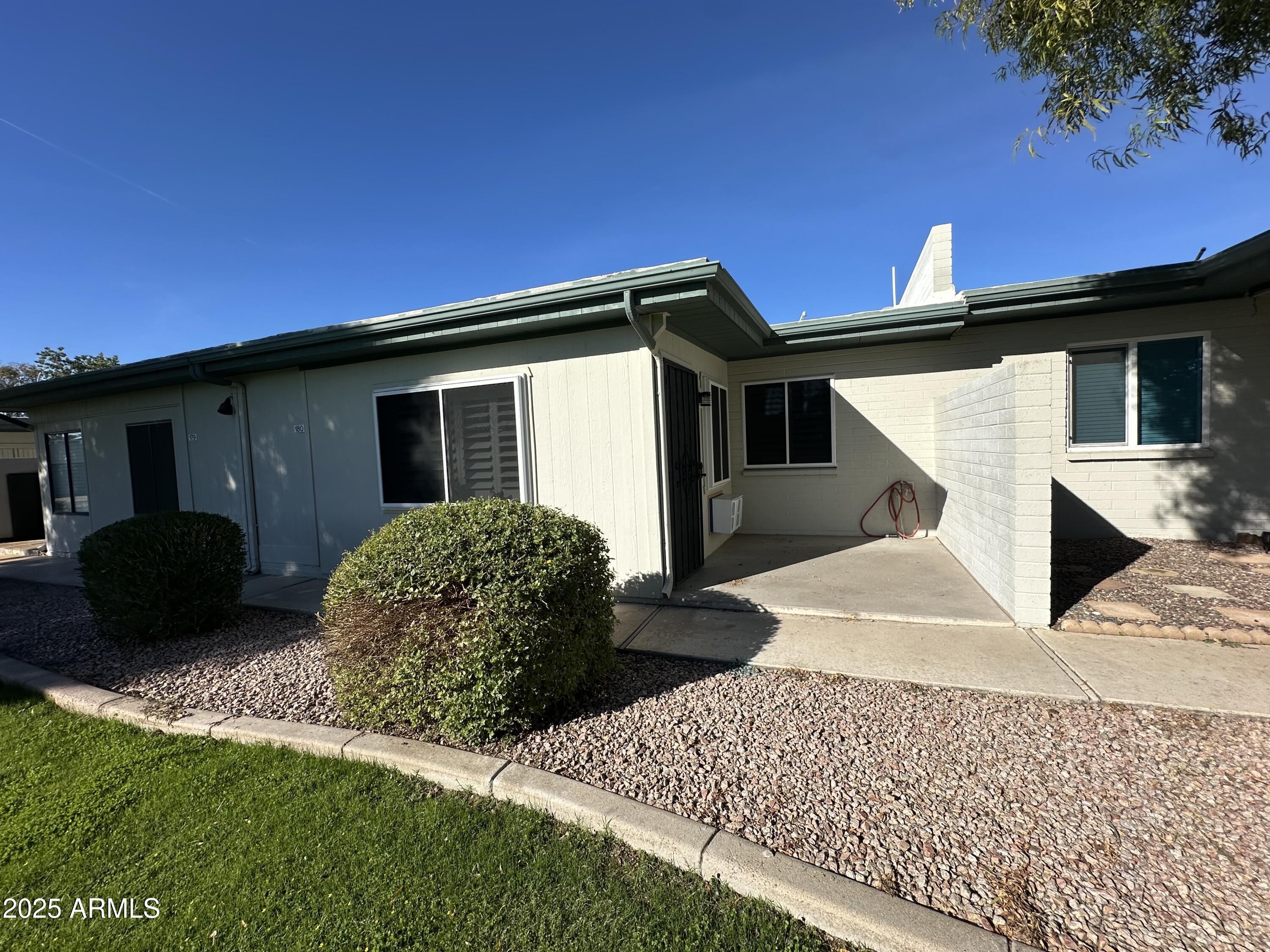 4328 East Capri Avenue, Unit 180 Mesa, AZ 85206 - Photo 36 of 38 a front view of a house with a yard