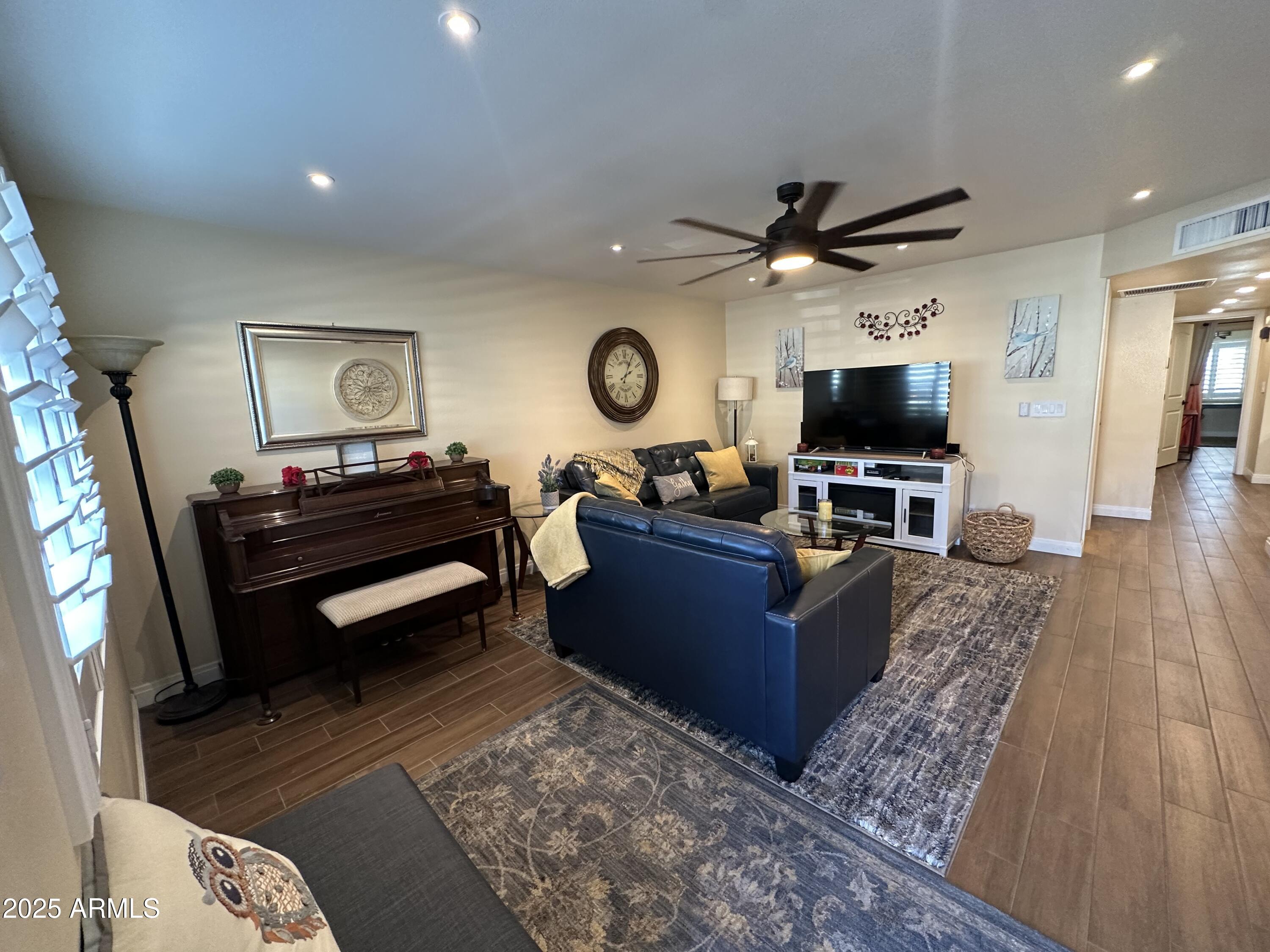 4328 East Capri Avenue, Unit 180 Mesa, AZ 85206 - Photo 5 of 38 a living room with furniture and a flat screen tv