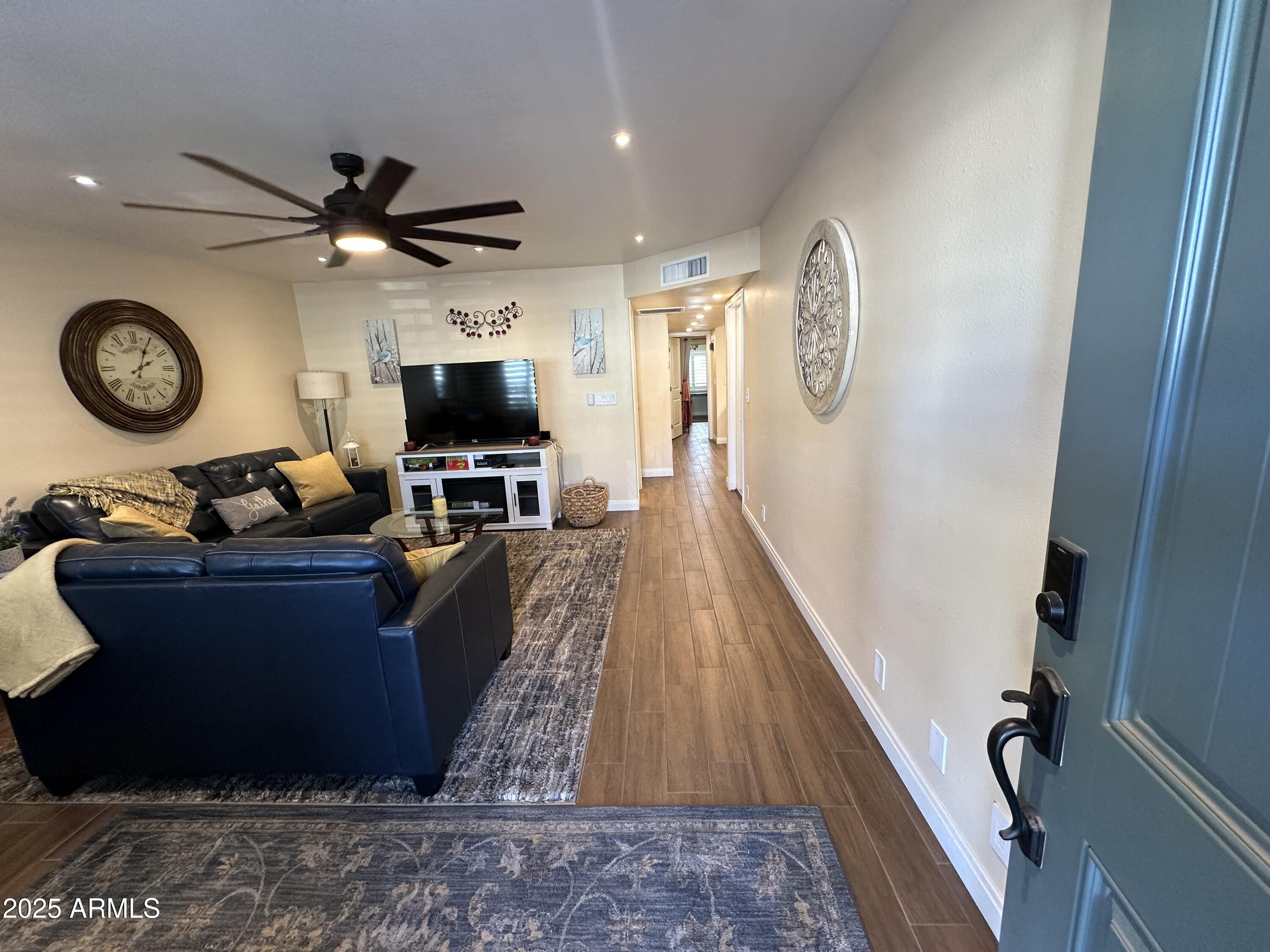 4328 East Capri Avenue, Unit 180 Mesa, AZ 85206 - Photo 6 of 38 a living room with furniture and a flat screen tv