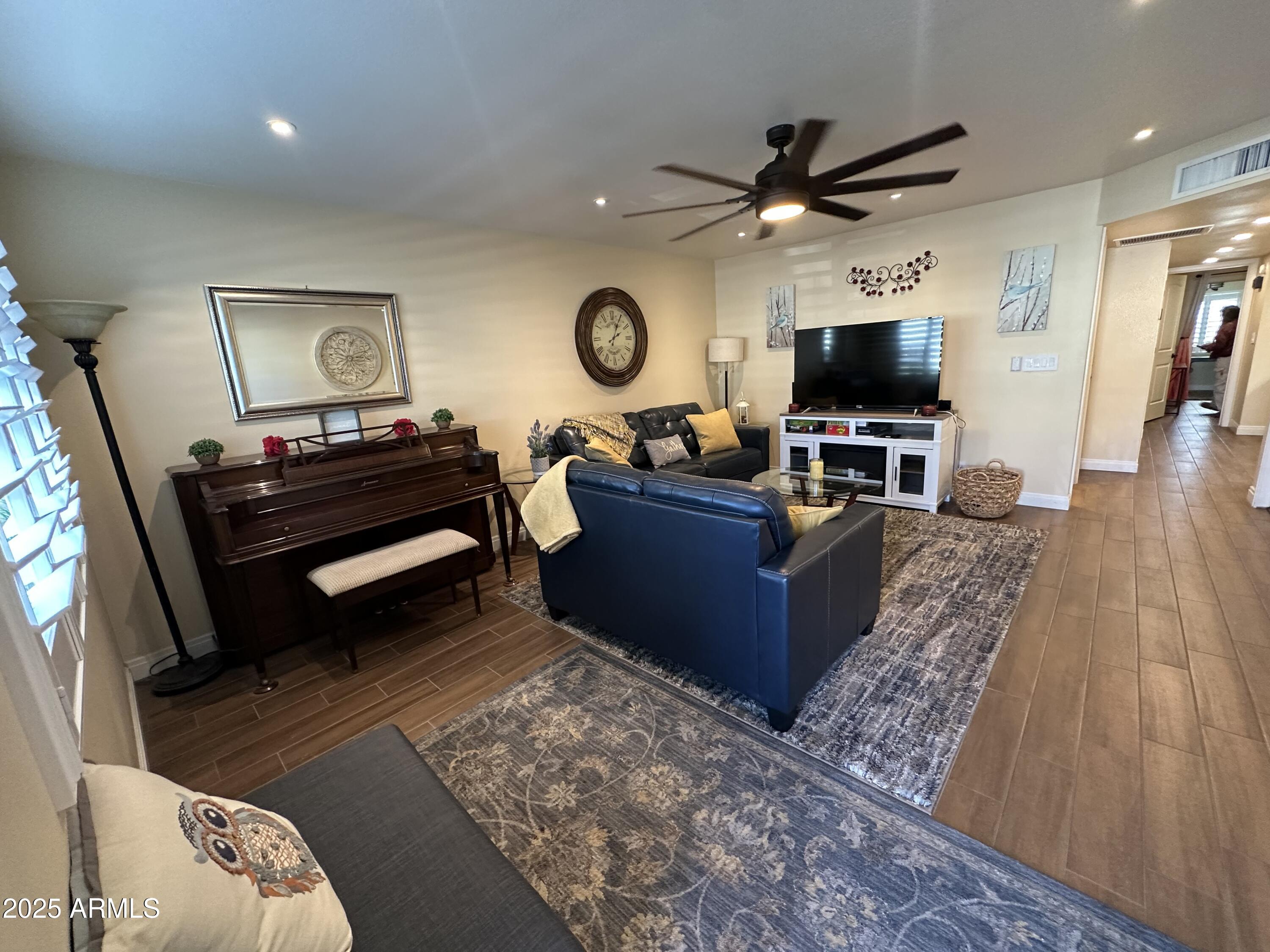 4328 East Capri Avenue, Unit 180 Mesa, AZ 85206 - Photo 7 of 38 a living room with furniture and a flat screen tv