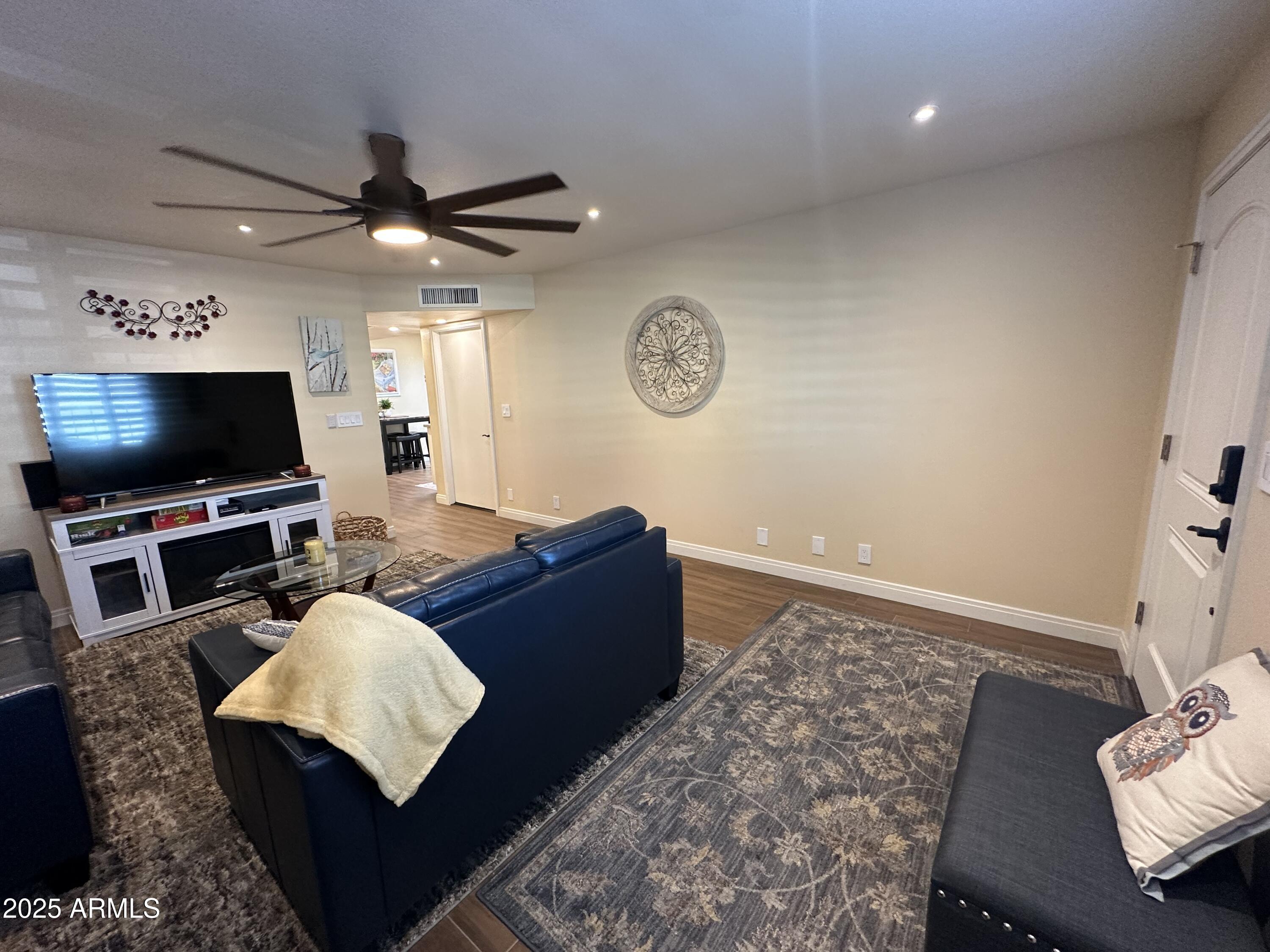 4328 East Capri Avenue, Unit 180 Mesa, AZ 85206 - Photo 8 of 38 a living room with furniture and a flat screen tv