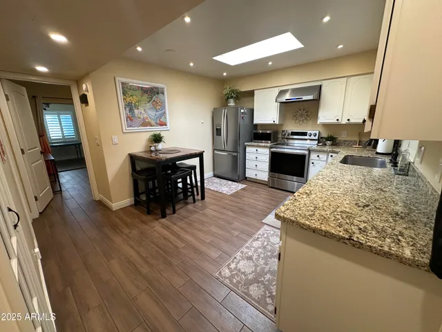 a stove top oven sitting inside of a kitchen