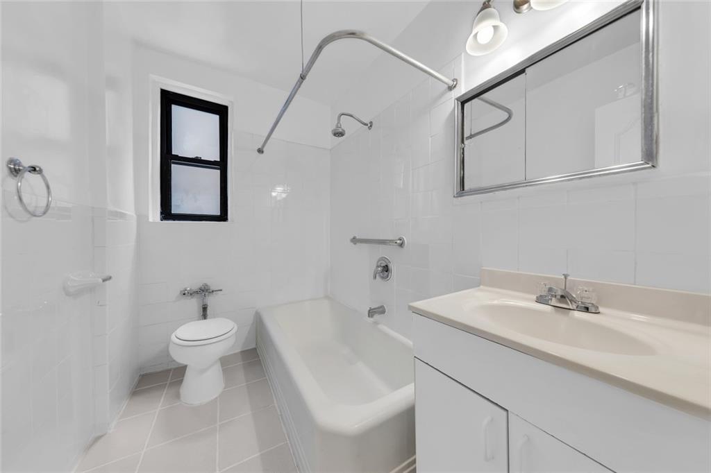 7401 Shore Road, Unit 2A Brooklyn, NY 11209 - Photo 12 of 22 a bathroom with a sink toilet and a mirror