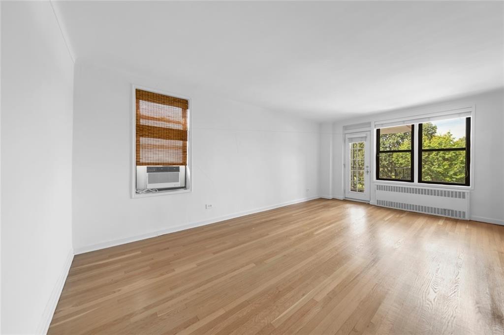 7401 Shore Road, Unit 2A Brooklyn, NY 11209 - Photo 2 of 22 an empty room with wooden floor and windows