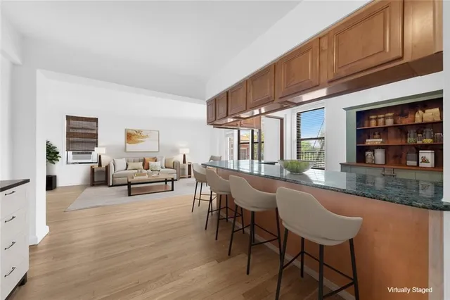 a living room with furniture a piano and a bookshelf