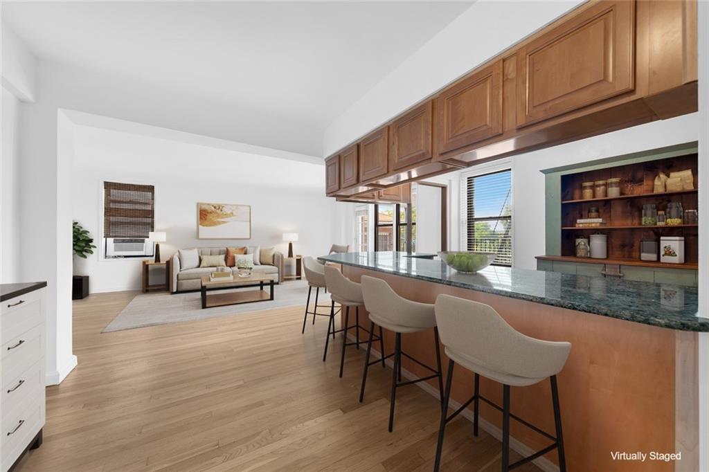 7401 Shore Road, Unit 2A Brooklyn, NY 11209 - Photo 9 of 22 a living room with furniture a piano and a bookshelf
