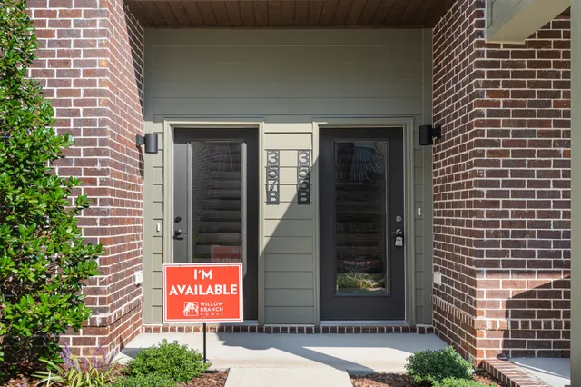a view of a brick building with a door and a window