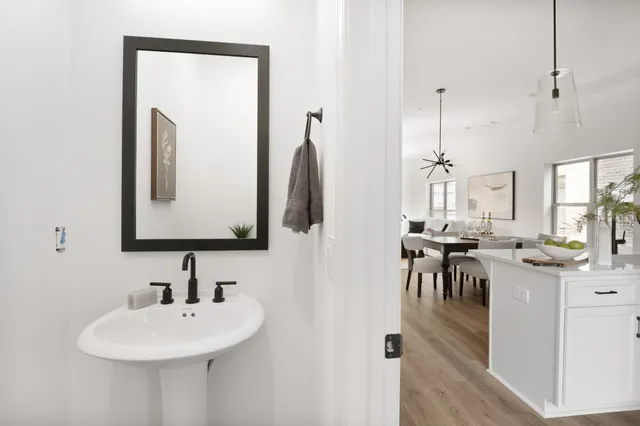 a view of a dining room with furniture and a mirror