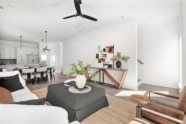 a living room with couches a coffee table and chairs