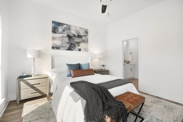 a bedroom with a bed and lamp