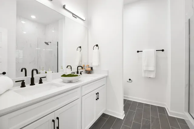 a bathroom with a double vanity sink and mirror