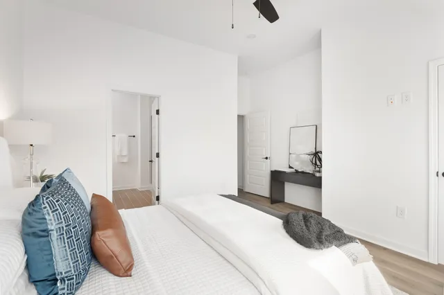 a bedroom with a bed and a chandelier