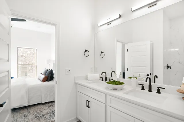 a bathroom with a double vanity sink and mirror
