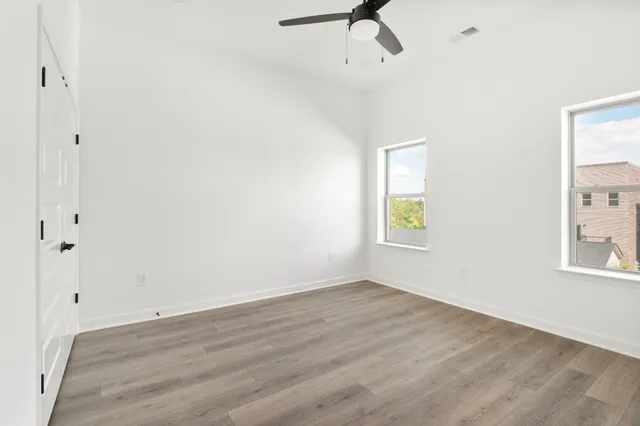 a view of room with hardwood floor and window