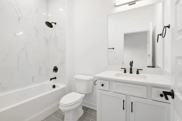 a bathroom with a sink a toilet and a bathtub