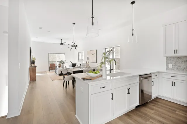 a kitchen with a sink dishwasher white cabinets and white appliances
