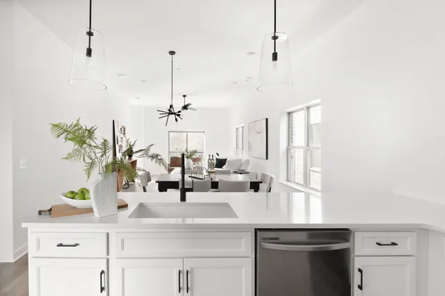 a kitchen with a sink and chandelier