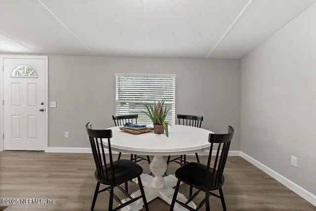 a dining room with furniture and wooden floor