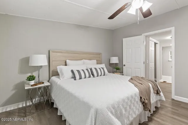 a bedroom with a bed and a chandelier