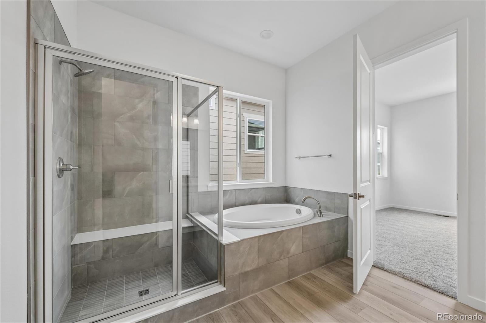 2516 West Bitterroot Place Highlands Ranch, CO 80129 - Photo 16 of 24 a bathroom with a tub shower and sink