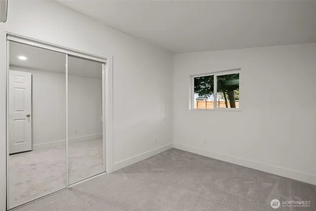 a view of an empty room with a bathroom