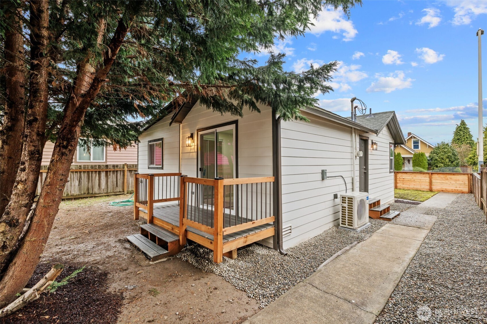 1521 North 3rd Street Renton, WA 98057 - Photo 15 of 18 a white house that has a tree in front of it