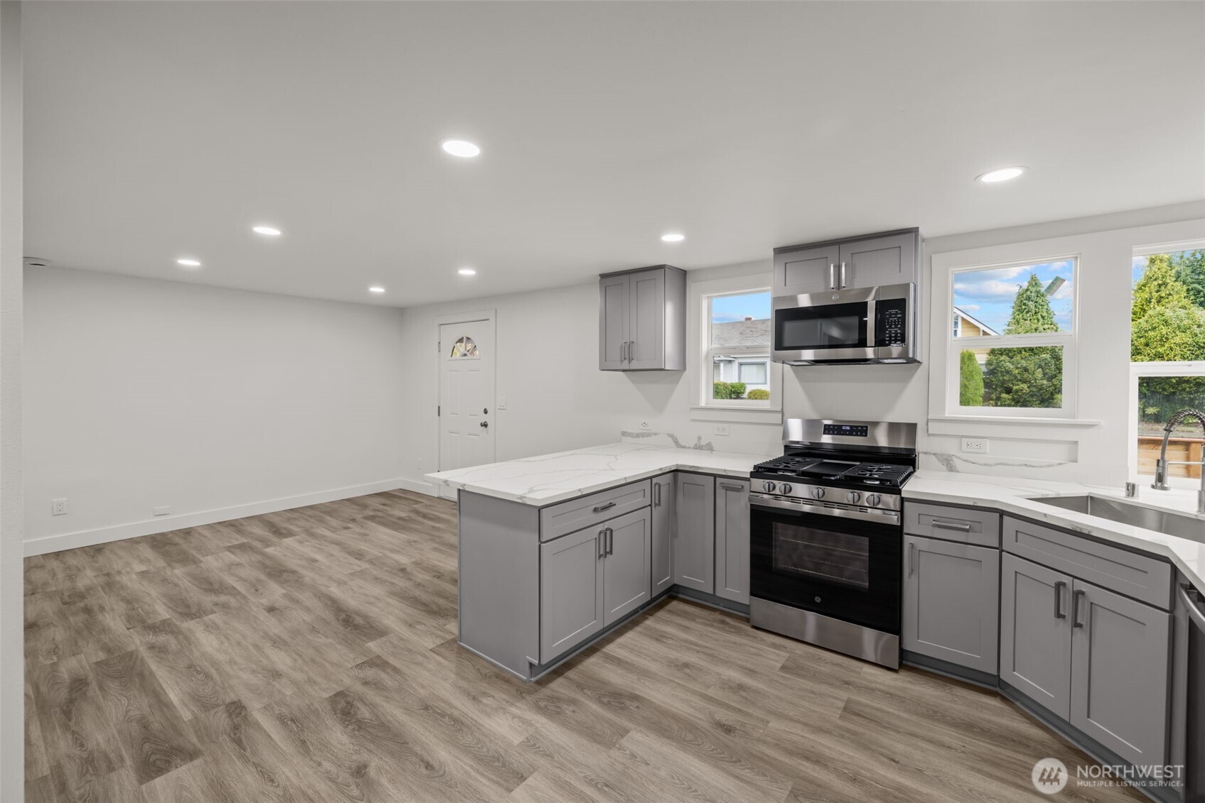 1521 North 3rd Street Renton, WA 98057 - Photo 5 of 18 a kitchen with stainless steel appliances granite countertop a stove a sink and a refrigerator