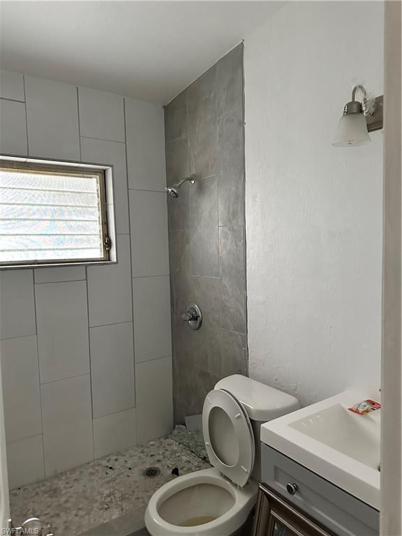 18633 Matanzas Road Fort Myers, FL 33967 - Photo 3 of 6 a bathroom with a sink a toilet and shower