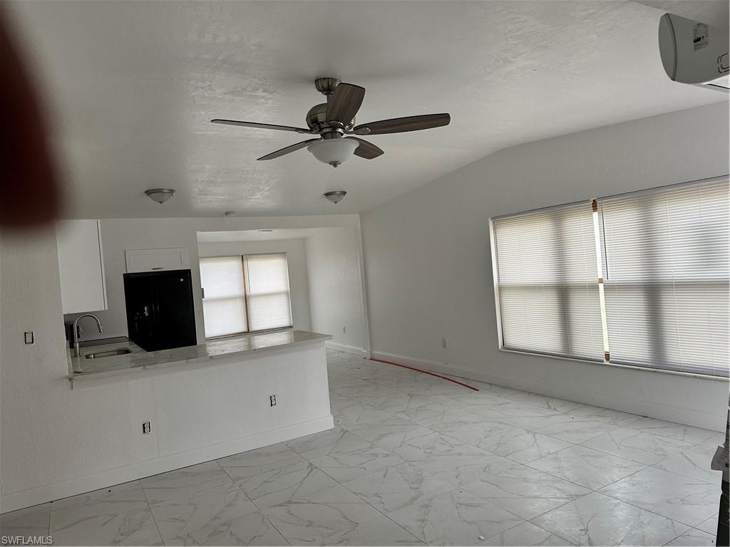 18633 Matanzas Road Fort Myers, FL 33967 - Photo 4 of 6 a view of empty room with a fireplace and windows