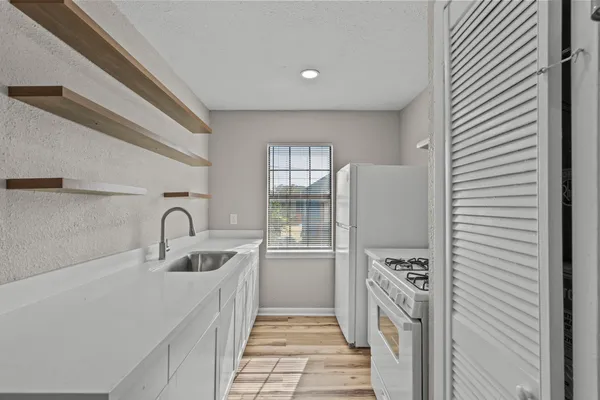a kitchen with refrigerator and cabinets