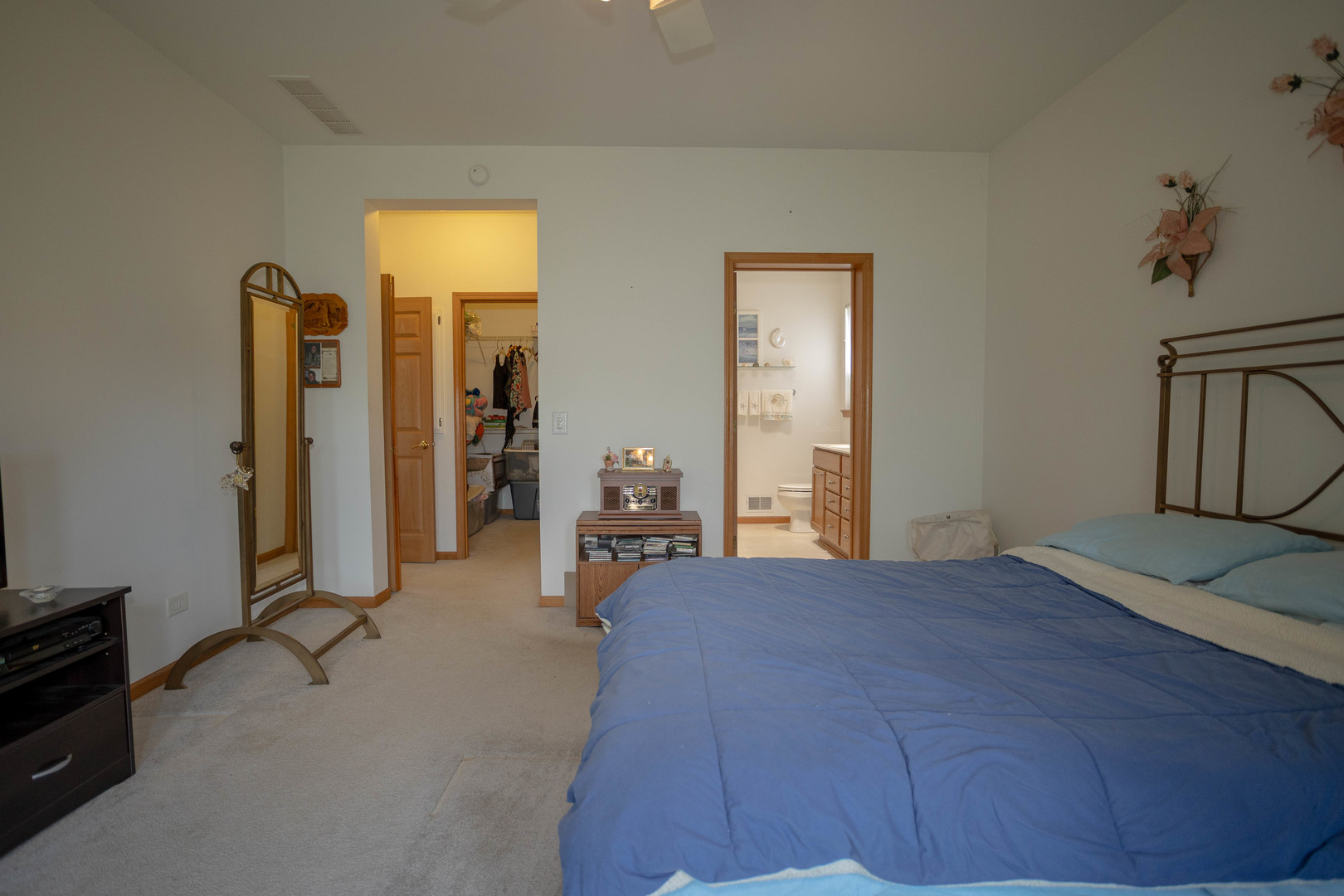 212 Rodeo Drive, Unit 2179 Grayslake, IL 60030 - Photo 23 of 31 a bedroom with a bed and a chandelier