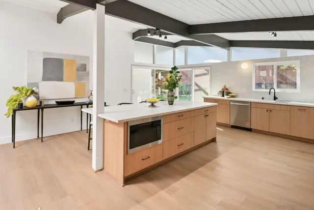 a dining room with furniture and a potted plant