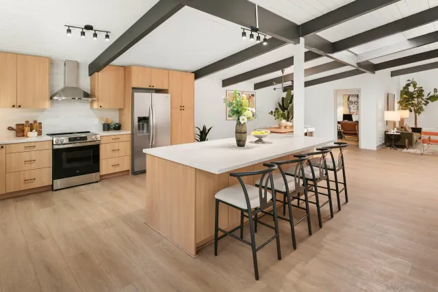 a bedroom with furniture and a large window