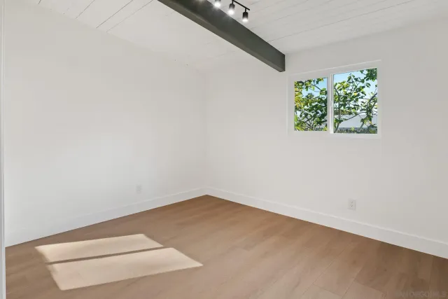 an aerial view of a house with a yard and large tree