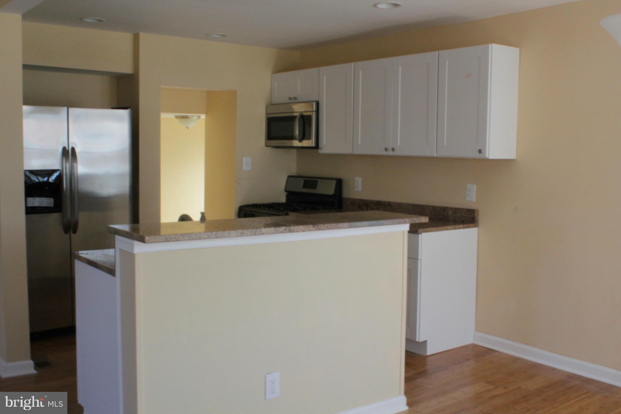 8129 Old Philadelphia Road Baltimore, MD 21237 - Photo 4 of 25 a kitchen with stainless steel appliances a refrigerator sink and microwave