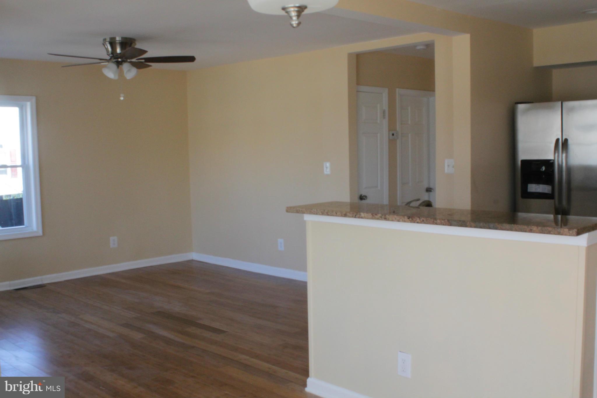 8129 Old Philadelphia Road Baltimore, MD 21237 - Photo 5 of 25 a view of a hallway with wooden floor