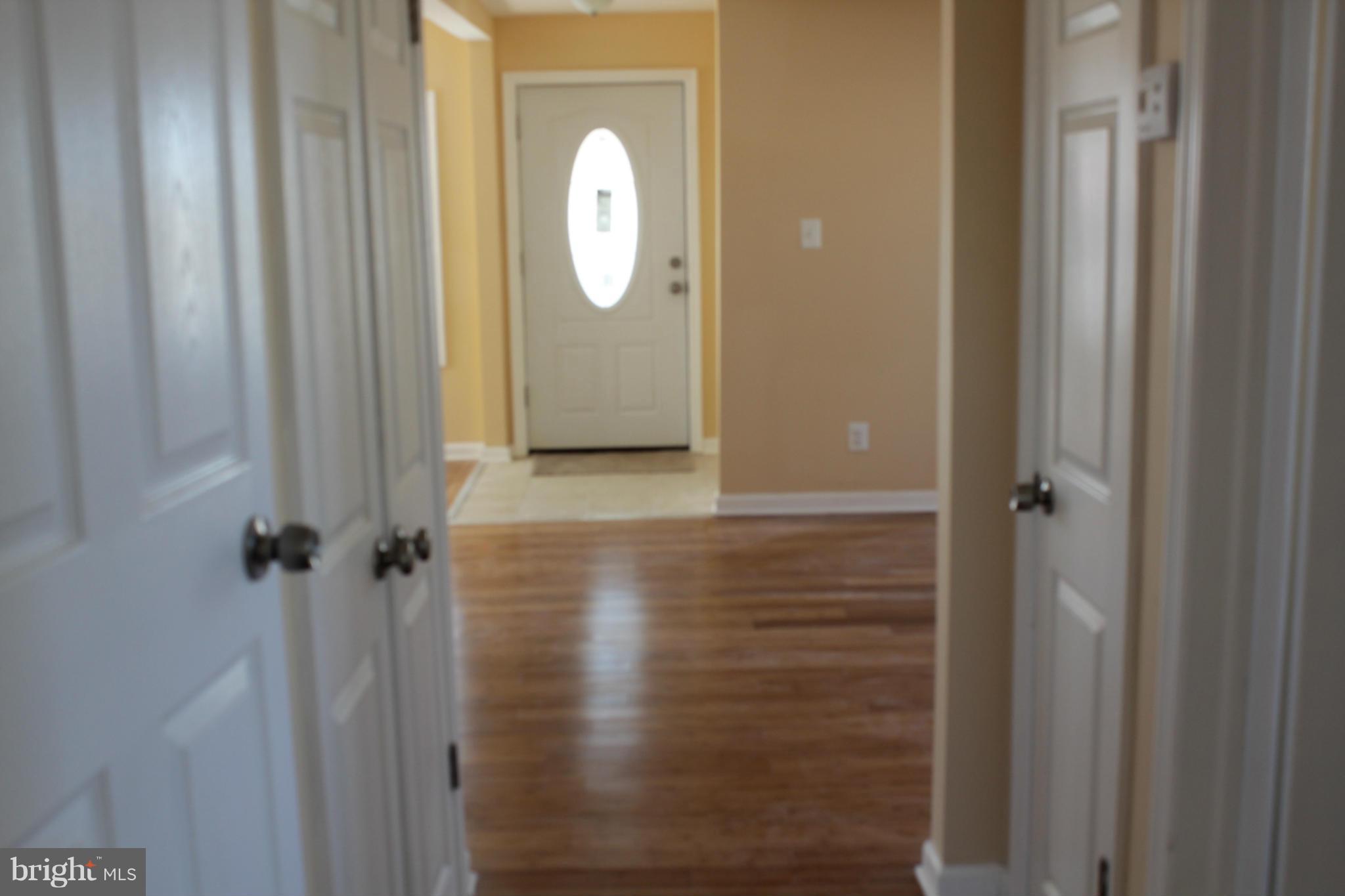 8129 Old Philadelphia Road Baltimore, MD 21237 - Photo 8 of 25 a view of a bathroom with wooden door