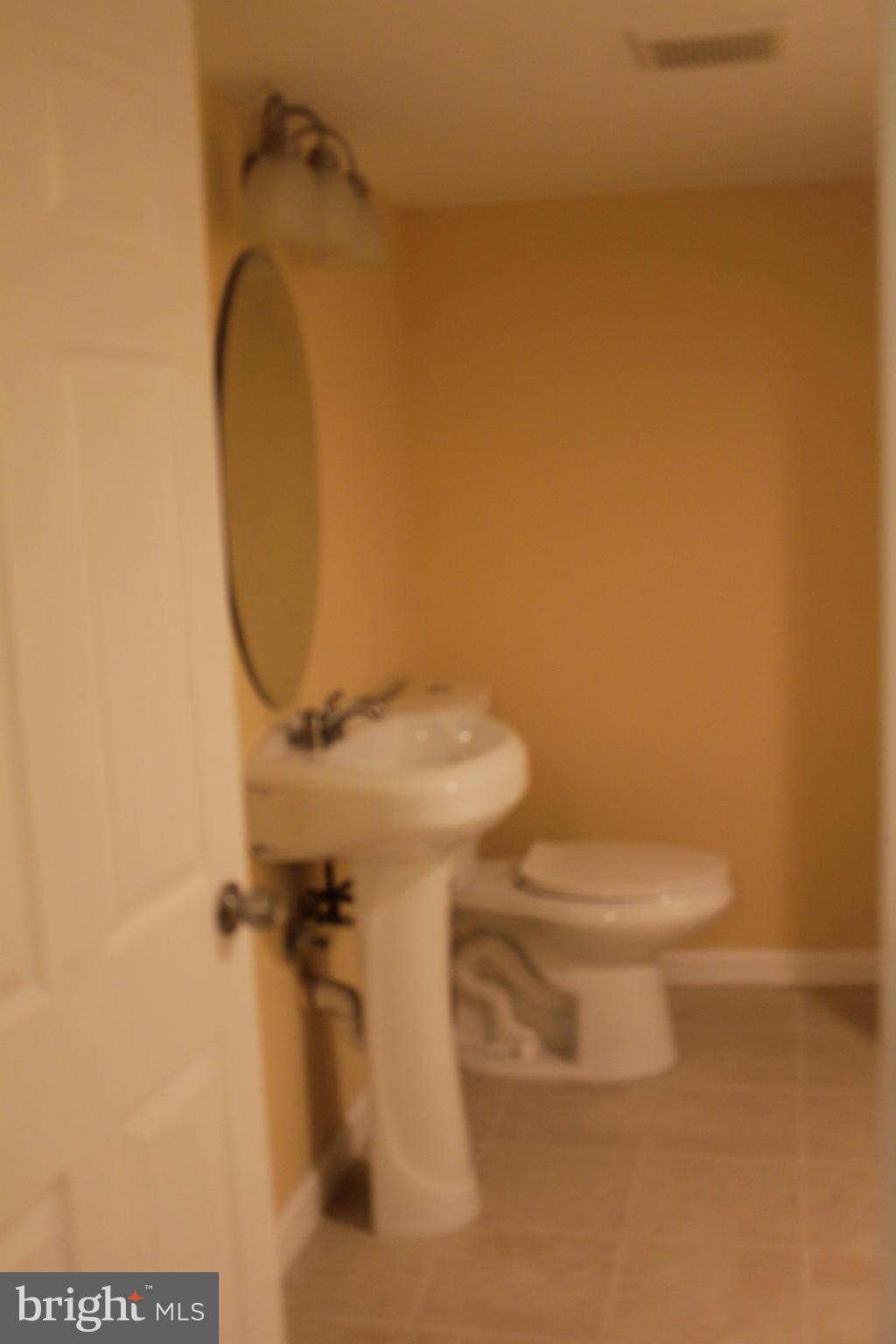 8129 Old Philadelphia Road Baltimore, MD 21237 - Photo 9 of 25 a bathroom with a toilet and a sink