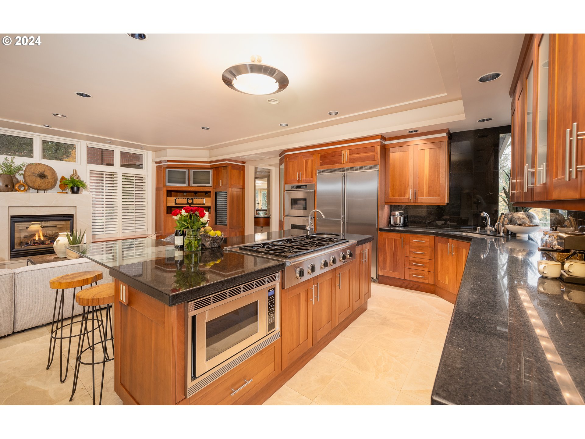 4335 Southwest Humphrey Boulevard Portland, OR 97221 - Photo 15 of 35 a kitchen with stainless steel appliances granite countertop a stove a sink and a microwave