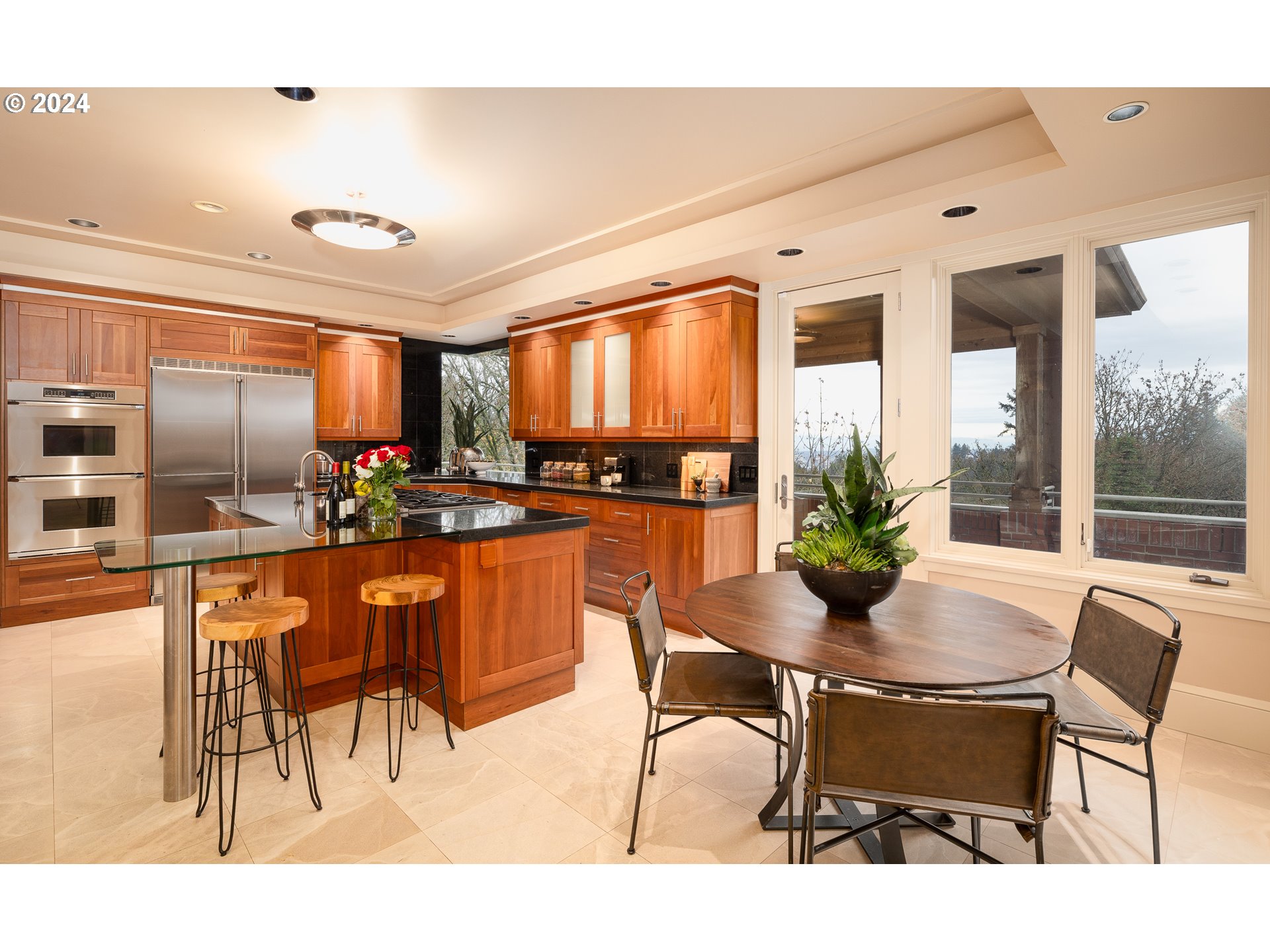 4335 Southwest Humphrey Boulevard Portland, OR 97221 - Photo 16 of 35 a dining room with furniture and a kitchen view