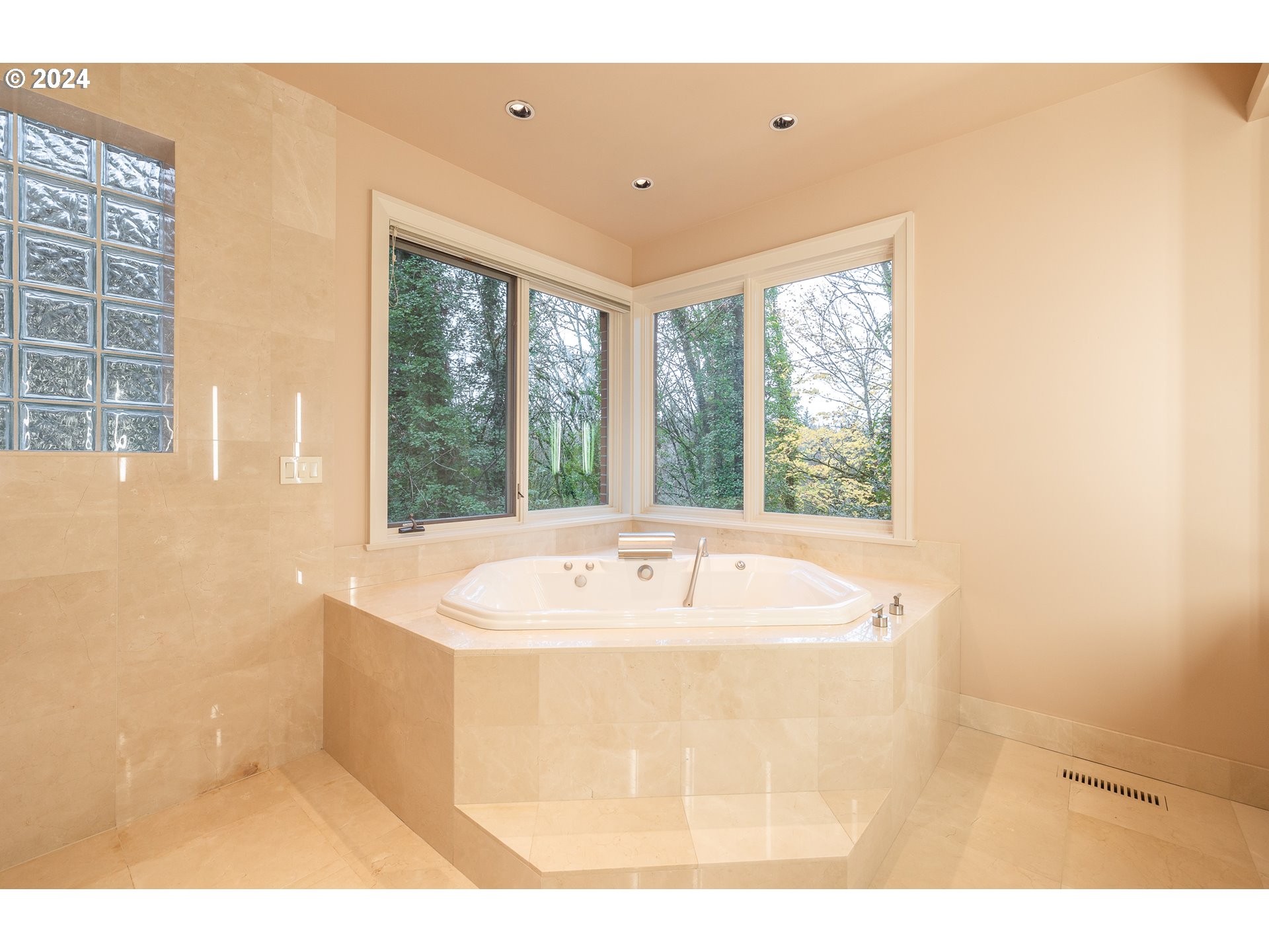 4335 Southwest Humphrey Boulevard Portland, OR 97221 - Photo 25 of 35 a bath tub sitting in a bathroom next to a window