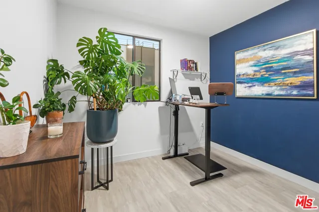 a view of a workspace with furniture and a potted plant