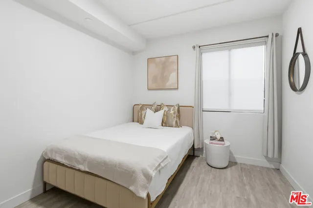 a bedroom with a bed and a table