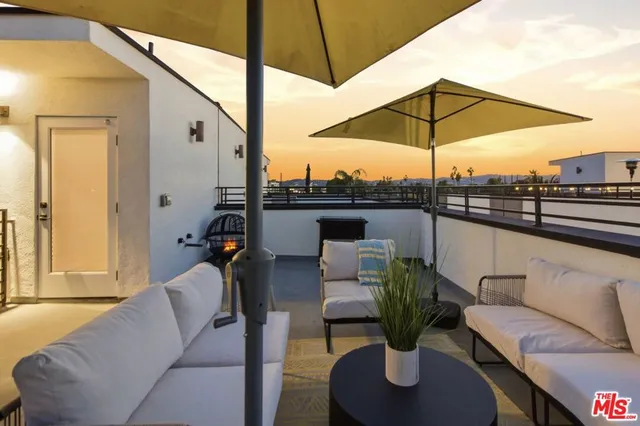 a view of a patio with couches and potted plants