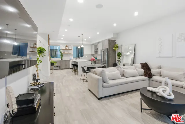 a living room with furniture kitchen and a table