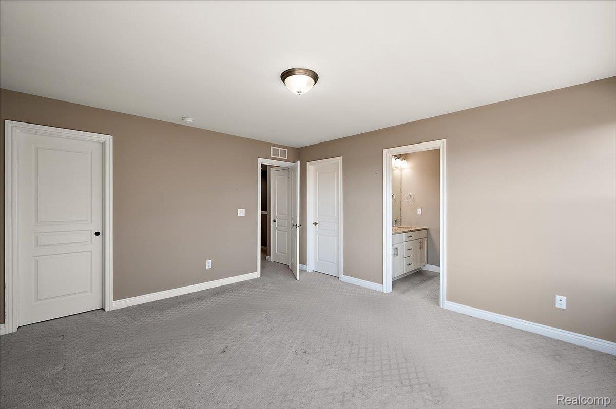 2877 Hartwick Drive Rochester, MI 48307 - Photo 34 of 44 Unfurnished bedroom featuring light carpet and connected bathroom