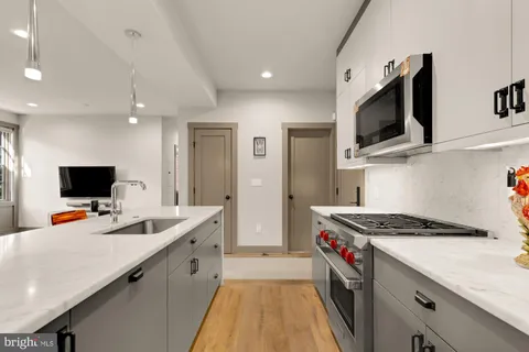 a kitchen that has a lot of cabinets and appliances